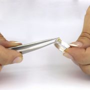 Placing a gem stone with tweezers